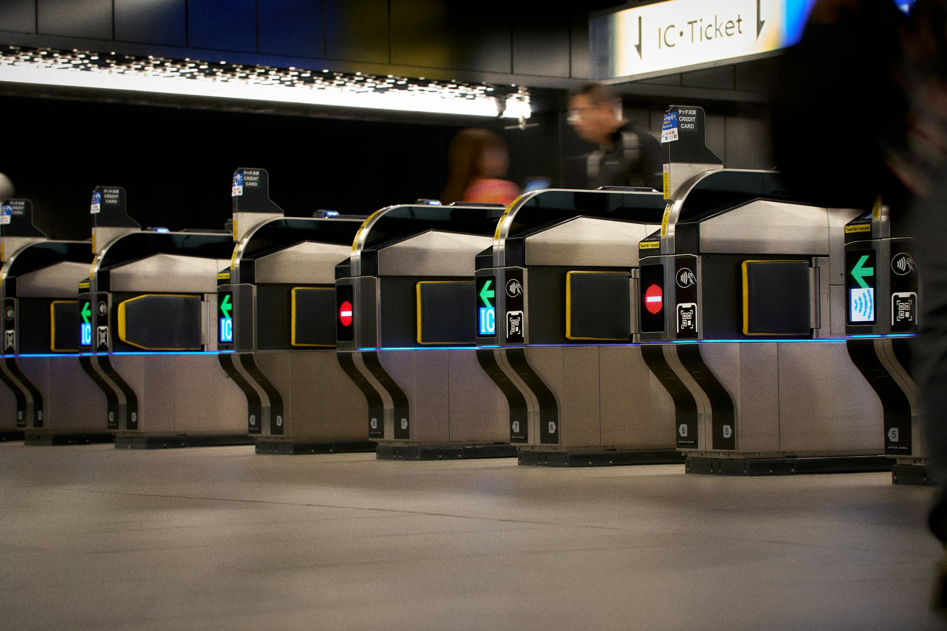 Row of ticket gates in a modern subway station